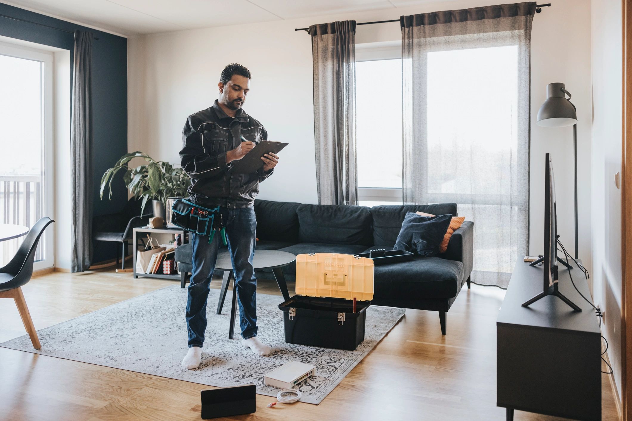 Technician reviewing a smart home installation with a homeowner