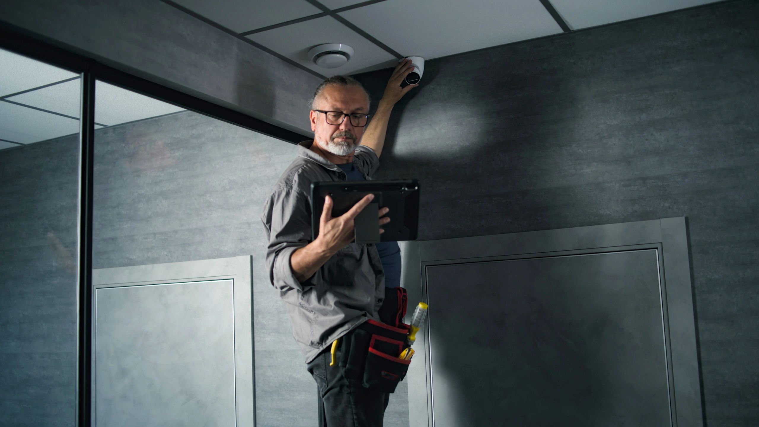 Technician configuring automation and security equipment